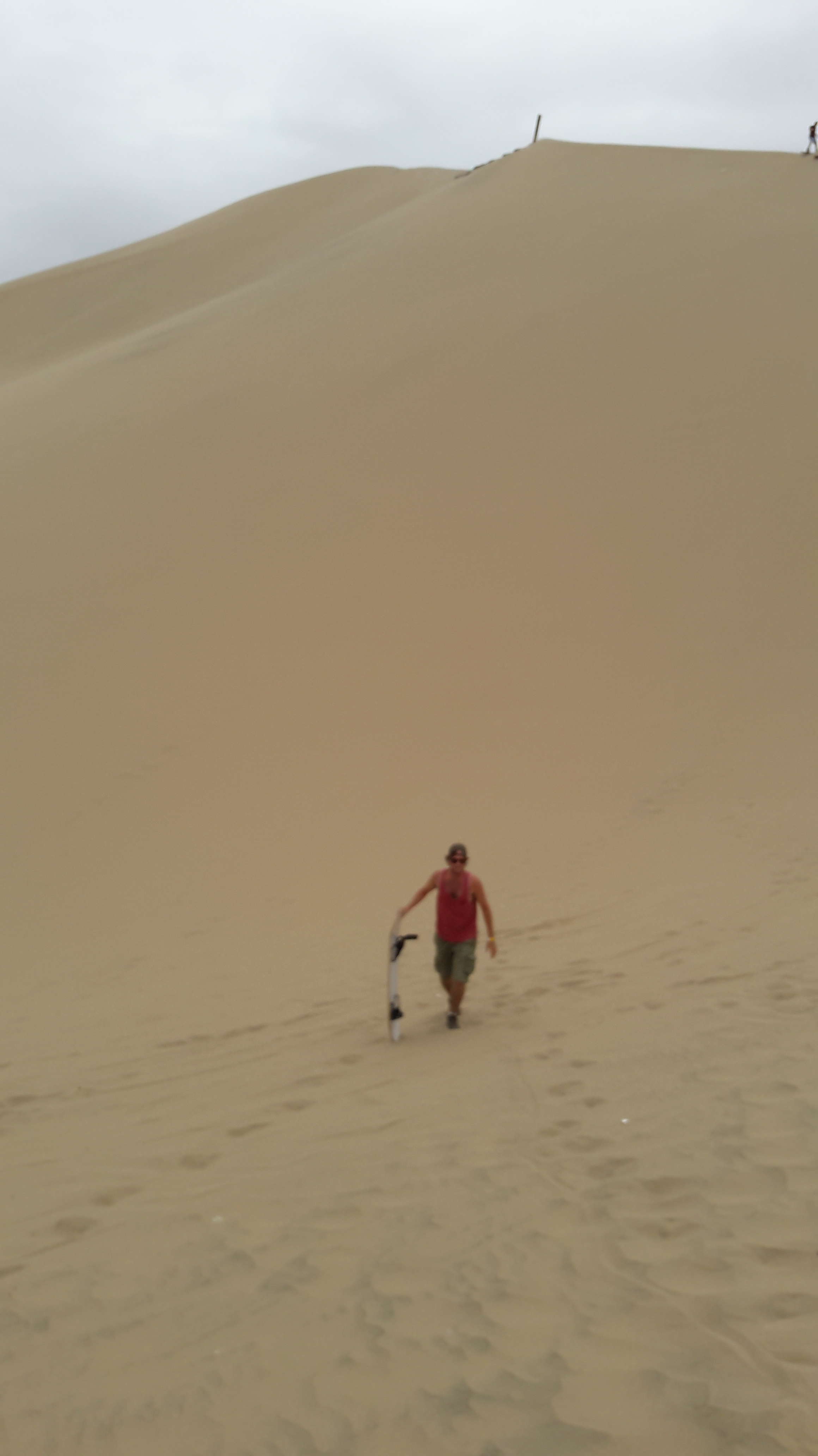 A man Sand boarding in Huacachina