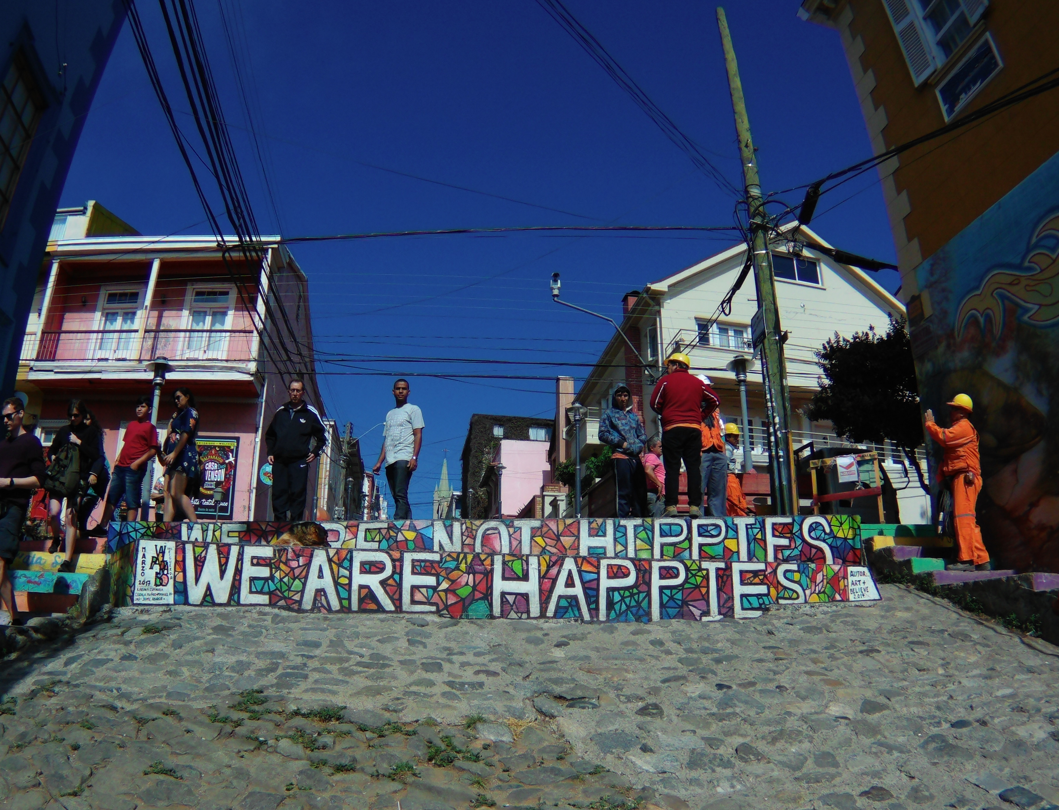 Mural on steps saying "We are not hippies, we are happies"